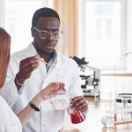 Laboratory laboratories conduct experiments in a chemical laboratory in transparent flasks. Output formulas